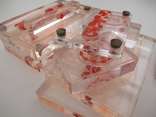 Rosma's stack of rubber stamps, which were custom pieces affixed to clear blocks from the Martha Stewart Crafts line. The ability to see through them allowed her to place the ink within the borders of the letterpressed designs.