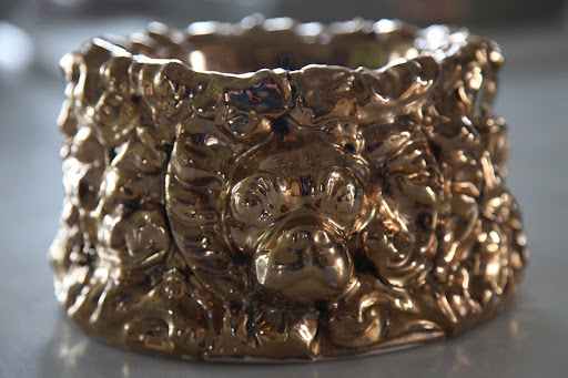 Oh my!  It's so artsy and even has a dog's face in its design.  It even looks like a French bulldog!