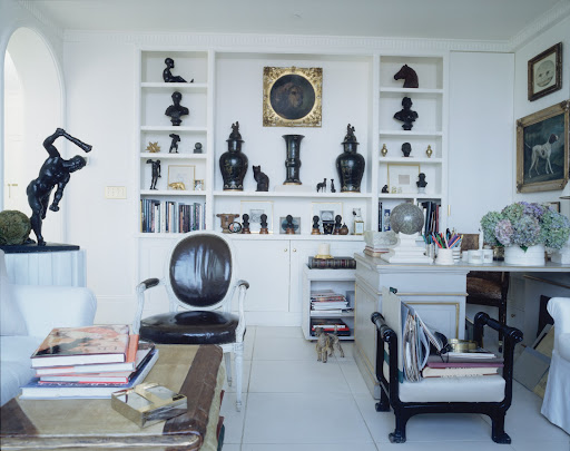 This built-in bookcase is the star of the room, featuring antique bronzes and a nineteenth-century dog portrait. This built-in bookcase is the star of the room, featuring antique bronzes and a nineteenth-century dog portrait.