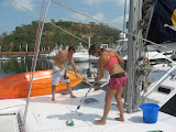 Lara and Jason swabbing the decks at the fuel dock