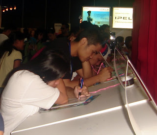 Students filing up entry forms. Some won free Sony bags, towels and CDs.