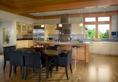 Modern kitchen showing island and dining table and chairs