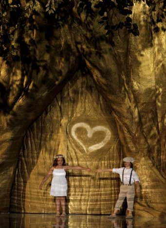 The show was told as a love story, starting with two kids—a girl and a boy—skipping up the runway and “carving” a heart on a spectacularly constructed golden tree. (Photo courtesy of Pronovias) The show was told as a love story, starting with two kids—a girl and a boy—skipping up the runway and “carving” a heart on a spectacularly constructed golden tree. (Photo courtesy of Pronovias)