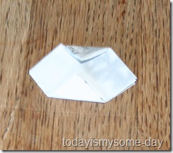 Fold both sides of your folded square inward to meet in the middle. The open Fold both sides of your folded square inward to meet in the middle. The open