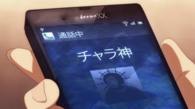 Up-close view of Kanade's phone as God is calling him, showing an icon that clearly resembles the infamous botched Jesus fresco restoration