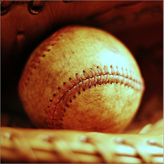 c0 A picture of an old baseball in a mitt.