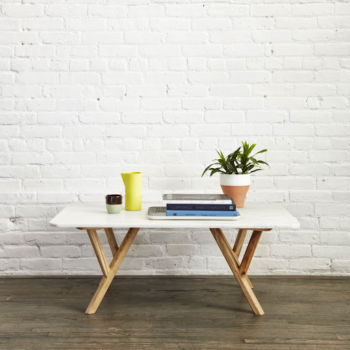 The chic coffee table has oiled ash legs and is available in white marble.