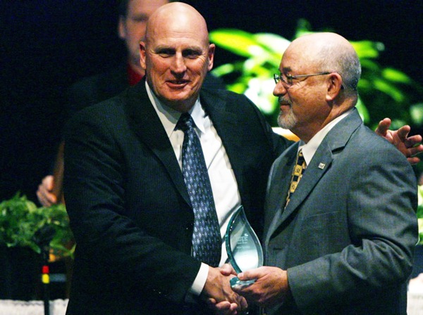 left Temple Head Football Coach and athletic director Mike Spradlin is presented an Impact Award by Dan Jones