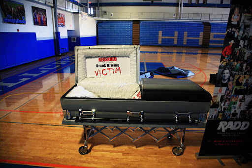 An empty coffin, reserved for a drunk driving victim, sits in the gym at Hillcrest High School.
(Photo Credit: Alex Crowder)