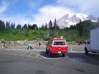Angie guards our stuff at the climber drop-off zone at Paradise. Mount Rainier looking unusually clear.