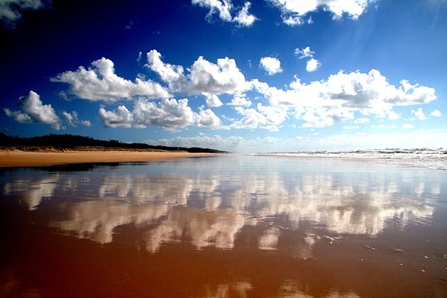 Clouds reflecting in the water on the Fraser island beach - Queensland - Australia