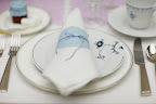 Napkins are folded and wrapped with blue dyed doilies (an idea from Living's May issue) and blue ribbon. Napkins are folded and wrapped with blue dyed doilies (an idea from Living's May issue) and blue ribbon.