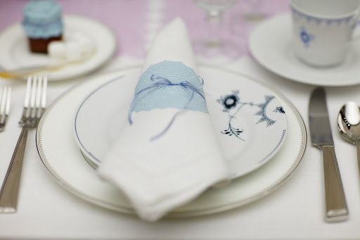 Napkins are folded and wrapped with blue dyed doilies (an idea from Living's May issue) and blue ribbon. Napkins are folded and wrapped with blue dyed doilies (an idea from Living's May issue) and blue ribbon.