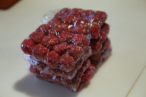 She portions out the meatballs into daily packets.