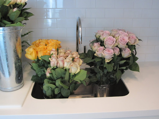 More roses wait to be used for table arrangements.