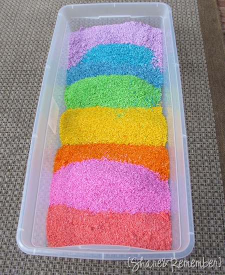 Rainbow of colored rice sensory bin colored with liquid watercolors Rainbow Rice & Garden Sensory Play