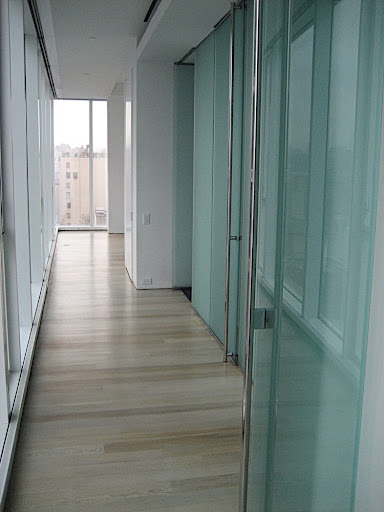 This is the hallway leading to my bedroom. It includes a wall of windows on the left and a wall of closets on the right. Those glass doors must go!