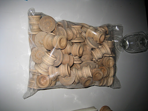 A bag of our wooden candlestick holders. Waiting to be sprayed.