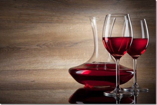 two Wine glass and decanter on a wooden Background
