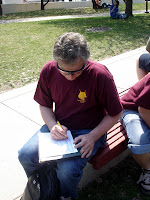 A teacher doing his schoolwork outside