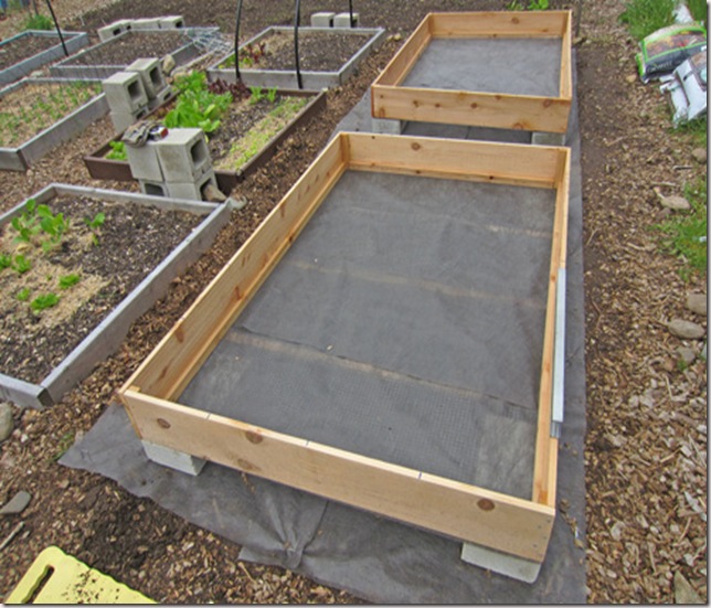 The boxes placed on blocks and squared up to the garden