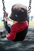 Oscar on the swings at Byron Bay
