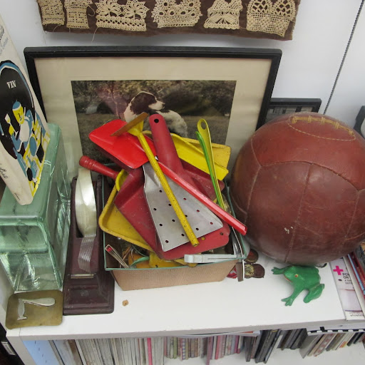 Vintage gardening tools and desk supplies can be found in another corner of the office.