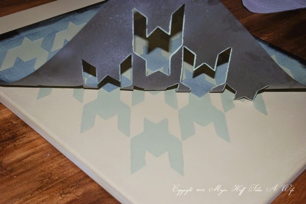 Peeling off a stencil off of canvas.jpg Peeling off a stencil off of canvas