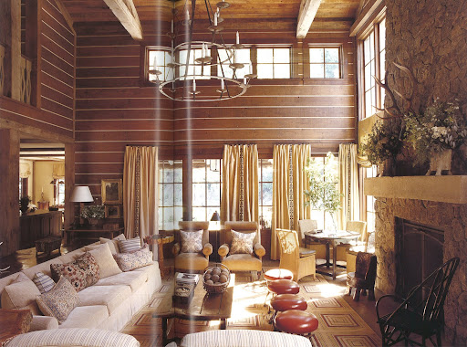 Perfect for entertaining year-round, this two-story living room is welcoming and comfortable yet has unique objects spread throughout that give the room personality. Perfect for entertaining year-round, this two-story living room is welcoming and comfortable yet has unique objects spread throughout that give the room personality.