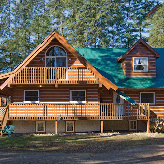 L shaped Ecolog cottage with covered porch in Haliburton County, Ontario