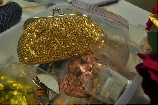 A David's Bridal clutch (http://www.davidsbridal.com) hanging in the glitter bin.