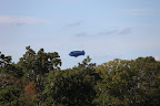 Oh, I get it now.  It's one of those advertising blimps.  Martha tells us how they often fly over stadiums, but why is it flying around here?