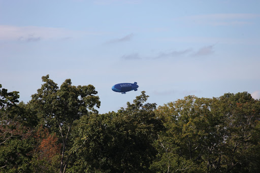 Oh, I get it now.  It's one of those advertising blimps.  Martha tells us how they often fly over stadiums, but why is it flying around here?
