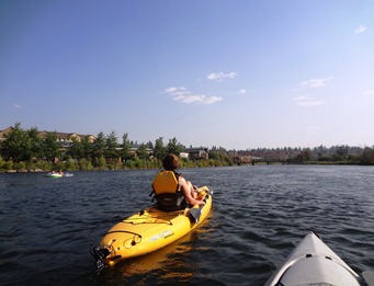 Pam and I kayaking through town on the Deschutes
