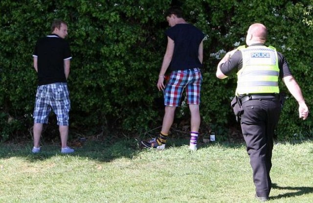 PIC BY GEOFF ROBINSON PHOTOGRAPHY 07976 880732.******NO BYLINE********PIC SHOWS POLICE STOPPING CAMBRIDGE UNIVERSITY STUDENTS URINATING ON JESUS GREEN,CAMBRIDGE,DURING CAESARIAN SUNDAY DRINKING PARTY.Passers-by were shocked to see more than 1000 drunken Cambridge University students STRIPPING OFF and VOMITING at a riotous summer term party in a PUBLIC park in the historic city centre.Families enjoying the spring sunshine were disgusted to see rowdy students downing excessive amounts of alcohol, then THROWING UP and WEEING in the park flower beds at midday on a Sunday afternoon.More than 1000 students attended yesterday's (May 1) annual party, known as Caesarian Sunday, which historically takes place on Jesus Green in Cambridge on the first bank holiday of the summer term.Many of them were members of the college drinking societies and spent the day taking part in shocking and bizarre initiation ceremonies.Girls were seen drinking port through condoms, while others wore kippers round their necks while they downed pints.SEE COPY CATCHLINE Cam Uni students drunk party