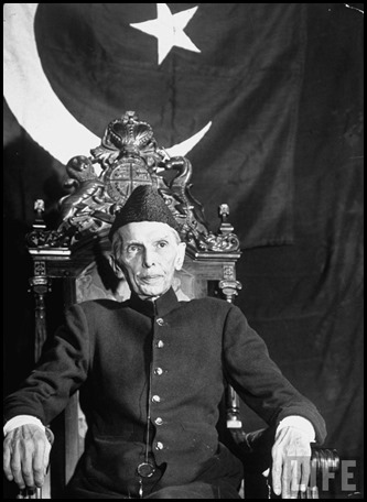 Mohammed Ali Jinnah sitting in front of Pakistani flag