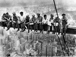 c0 Construction workers have lunch on a girder in 1932