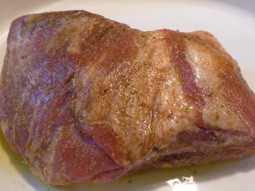 Pork shoulder butterflied, rubbed with spice mix and closed-ready for the oven.
