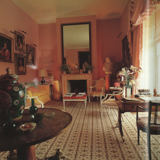 A stately room hung with pink cotton and furnished with dark wood appeals to both feminine and masculine tastes. A stately room hung with pink cotton and furnished with dark wood appeals to both feminine and masculine tastes.
