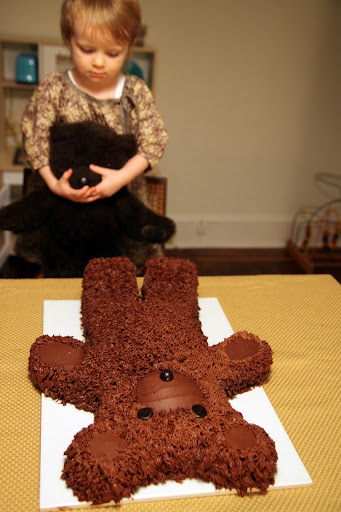 Birthday girl shows Big Bear her cake