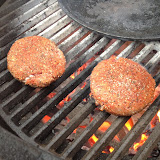 Old-school burger cooking over an open flame.