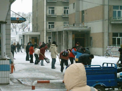 Students movin the snow off campus. The 1st years get stuck with this job each year!