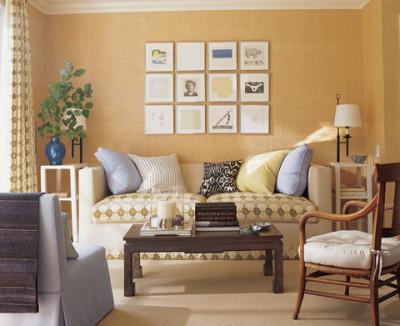The grass cloth covered walls in this living room remind me of my last apartment. I also love the display of framed artwork above the sofa. Image via habituallychic.blogspot.com