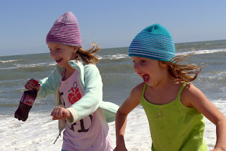 Girls run from the water.