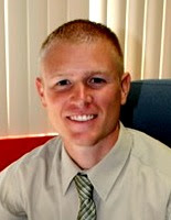 It's unknown whether Stewart Elementary Principal Adam Miller will be smiling at next week's pig-kissing event, as he is in this photo from the school district's website (Washington Community School District)