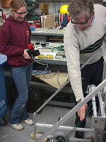 A mentor explaining our design to a student