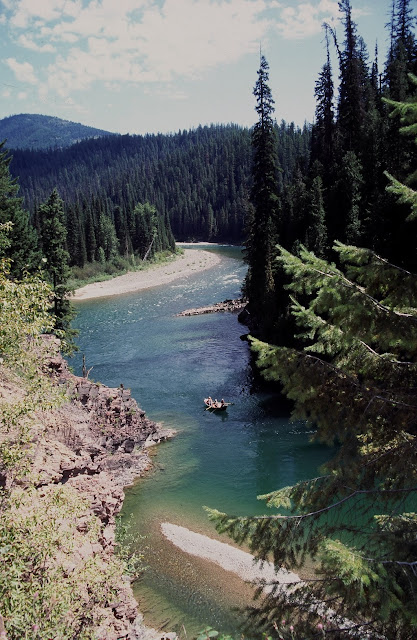 America The Beautiful - A drift boat slips quietly down the North Fork of the Flathead River in Northwest Montana. The North Fork travels through some of Montana's most spectacular scenery, including the western perimeter of Glacier National Park. The fishing is good, though not nearly as good as the Flathead's South Fork, which travels out of the Bob Marshall Wilderness. Still, the North Fork is well worth a day-long float. Be sure to bring your camera.