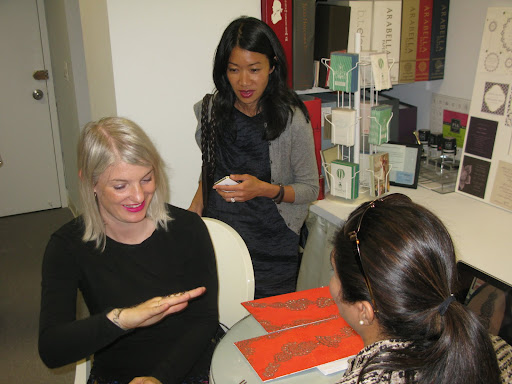 Style director Kate Berry looks on as associate style editor Naomi deManana receives a henna tattoo. What a great idea for a bridal shower activity!