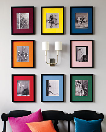 Create a rainbow of colorful mats is a prime example to bring a bit of zip to a collection of black-and-white images. Try old family photographs or convert color ones to black-and-white, and then unify the group with slender, gallery-style black frames.  (marthastewart.com)