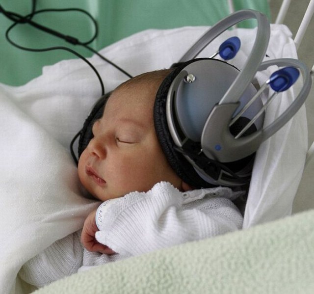 Newborn Bruno listens to music through headphones at the Saca hospital in Kosice, Slovakia, Tuesday, May 10, 2011. The hospital uses music therapy to help newborn babies that have to be separated from theirs moms for treatment. (AP Photo/Petr David Josek)